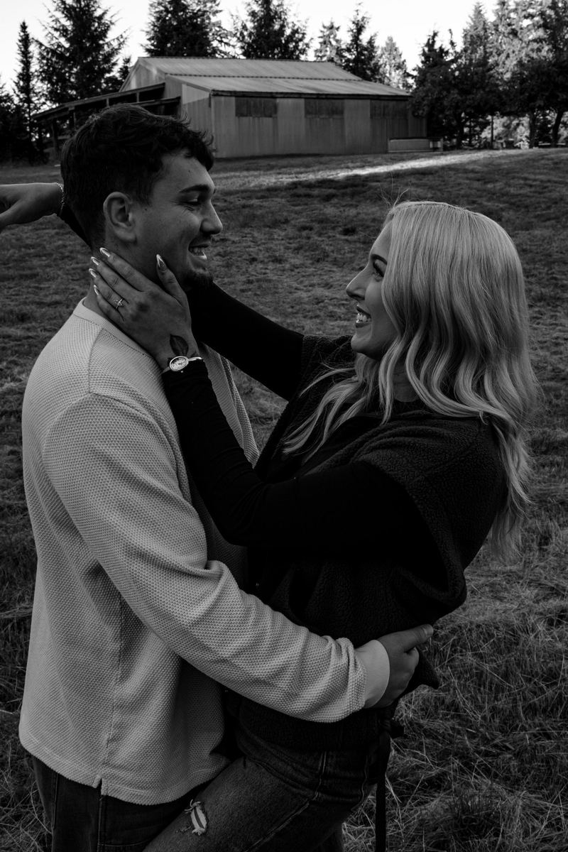 Black and white photo of a couple laughing in each other's arms