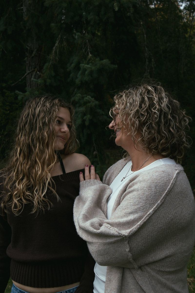 Mother and daughter sharing a quiet moment in the woods
